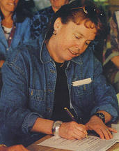 MacMillan Bloedel's Linda Coady, signing the Clayoquot agreement. Photo by Craig Paskin.